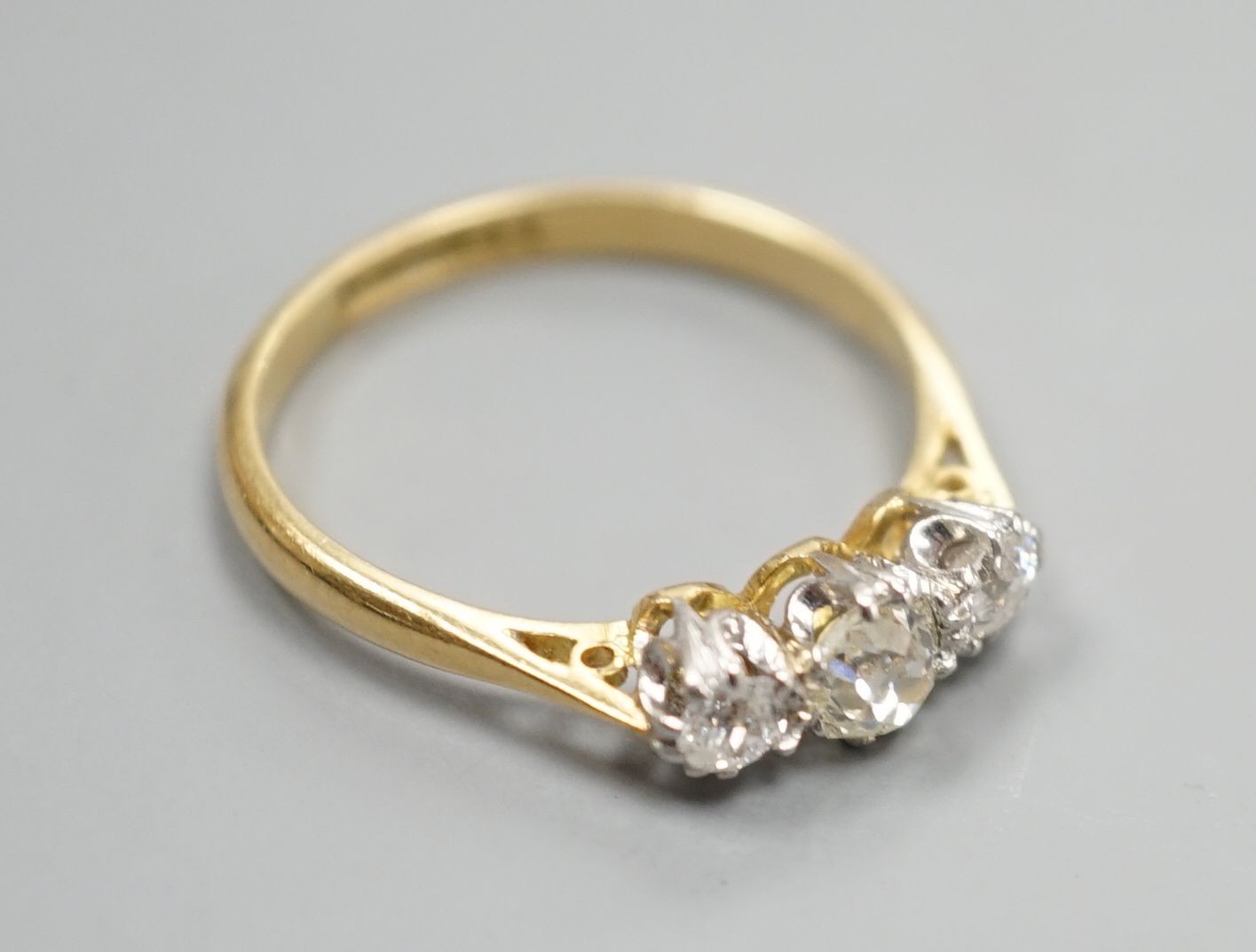 An 18ct & plat, three stone diamond ring, size L, gross weight 2.3 grams.
